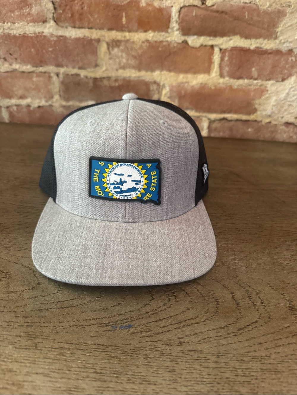 Heather Gray and Black Trucker Hat with Blue-Yellow State Patch